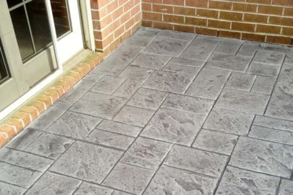 Stamped concrete is concrete that has been patterned and textured to resemble design elements like brick, tile, stone, or even wood. stamped concrete
